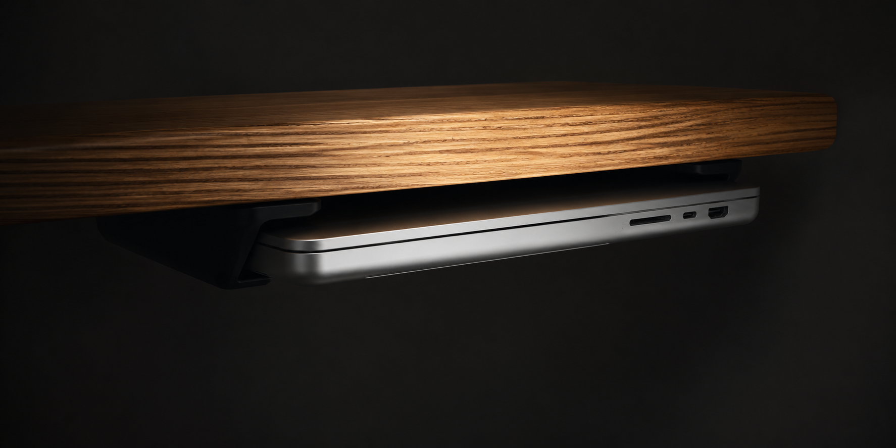 SOLODock mounted beneath a desk with a MacBook