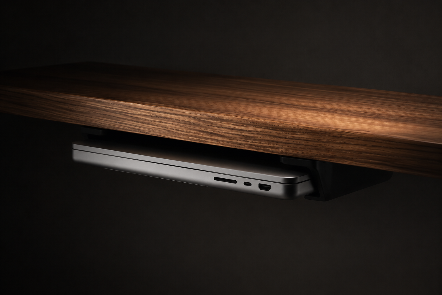 SOLODock installed beneath a desk with a MacBook docked inside